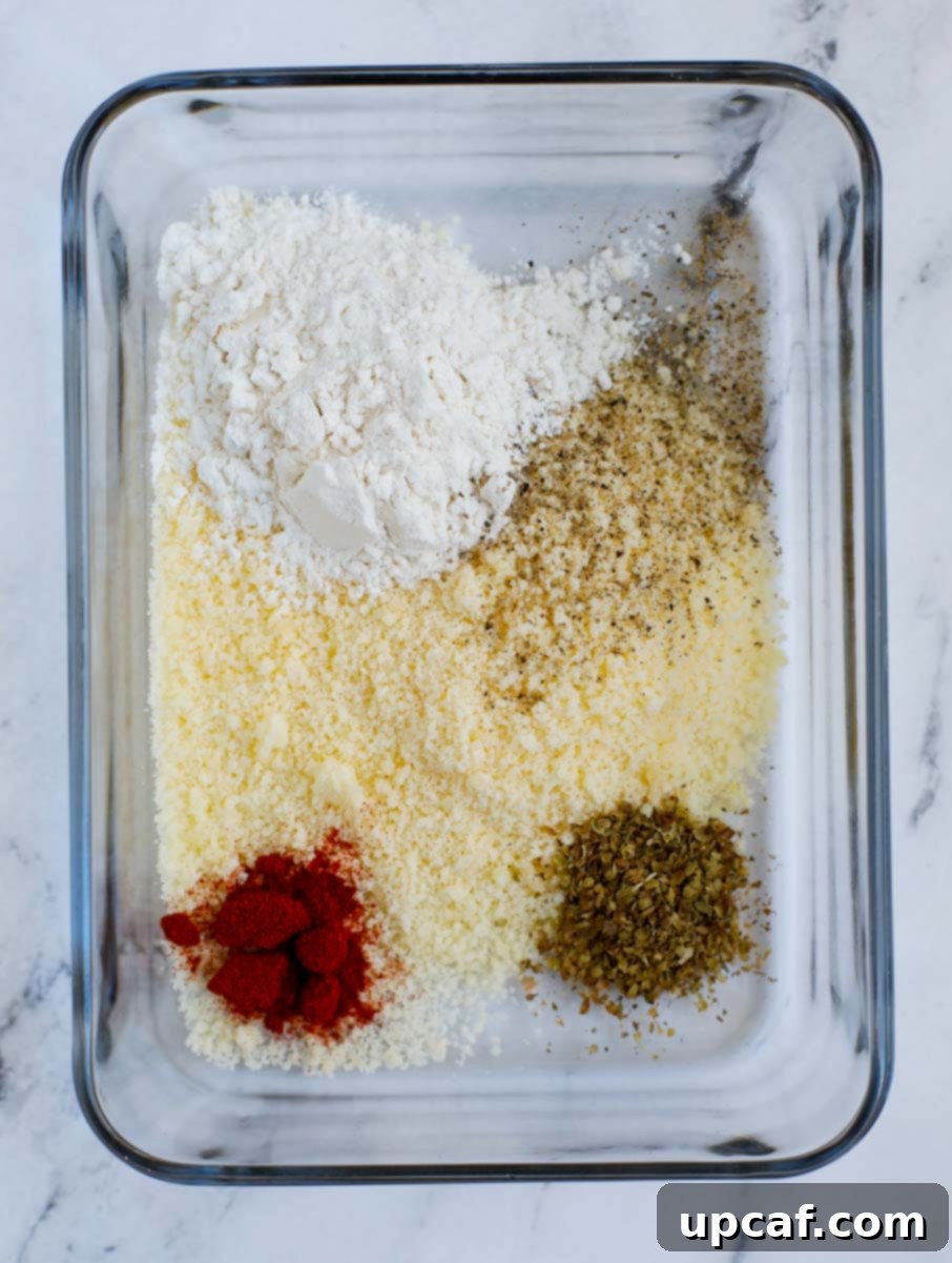 Dry breading mixture with flour, Parmesan cheese, and spices in a bowl.