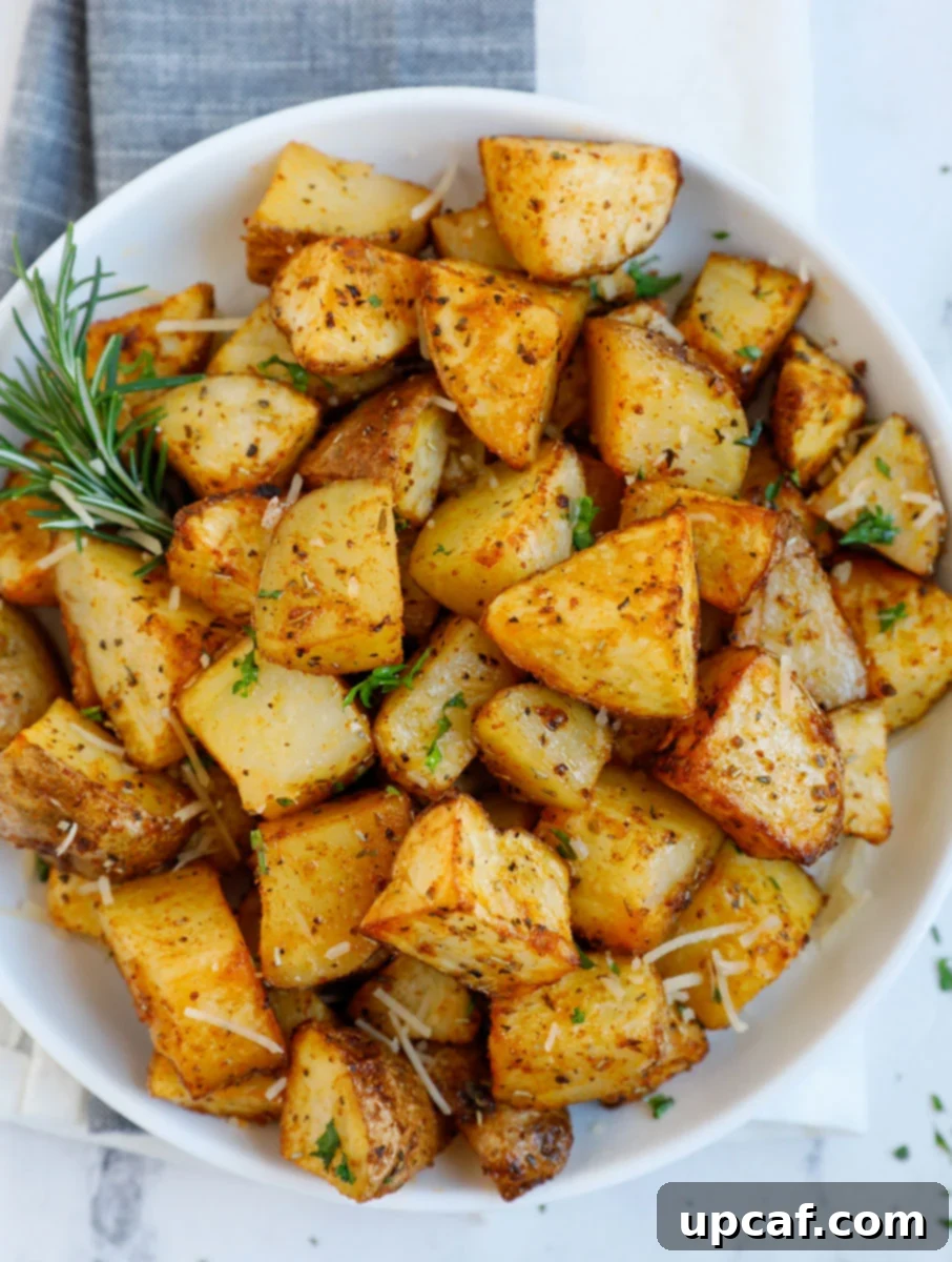 Overhead image of diced air fryer roasted potatoes on a plate.