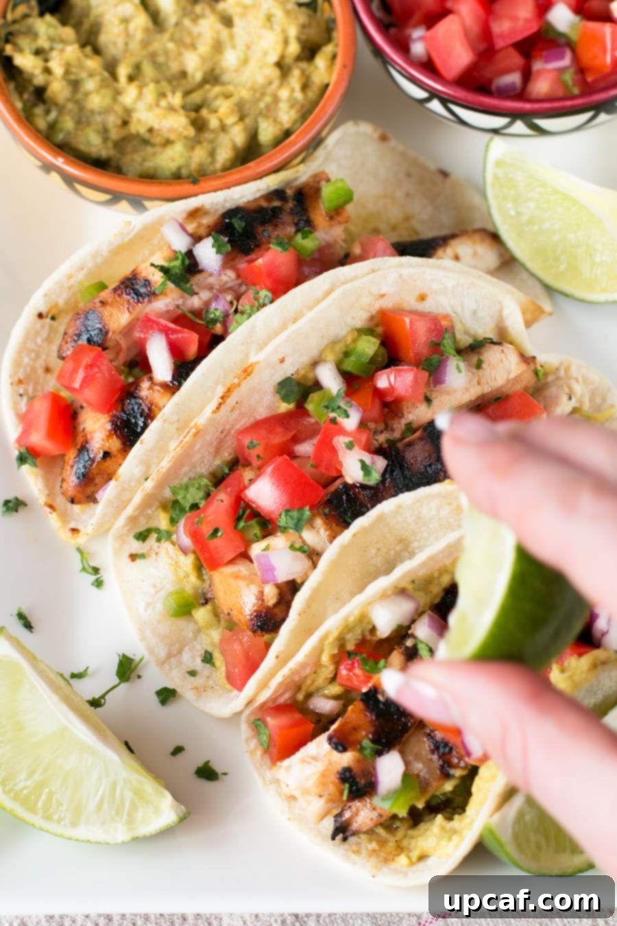Fiesta Chicken Tacos 3 Squeezing fresh lime juice over a plate of delicious Mexican Chicken Tacos
