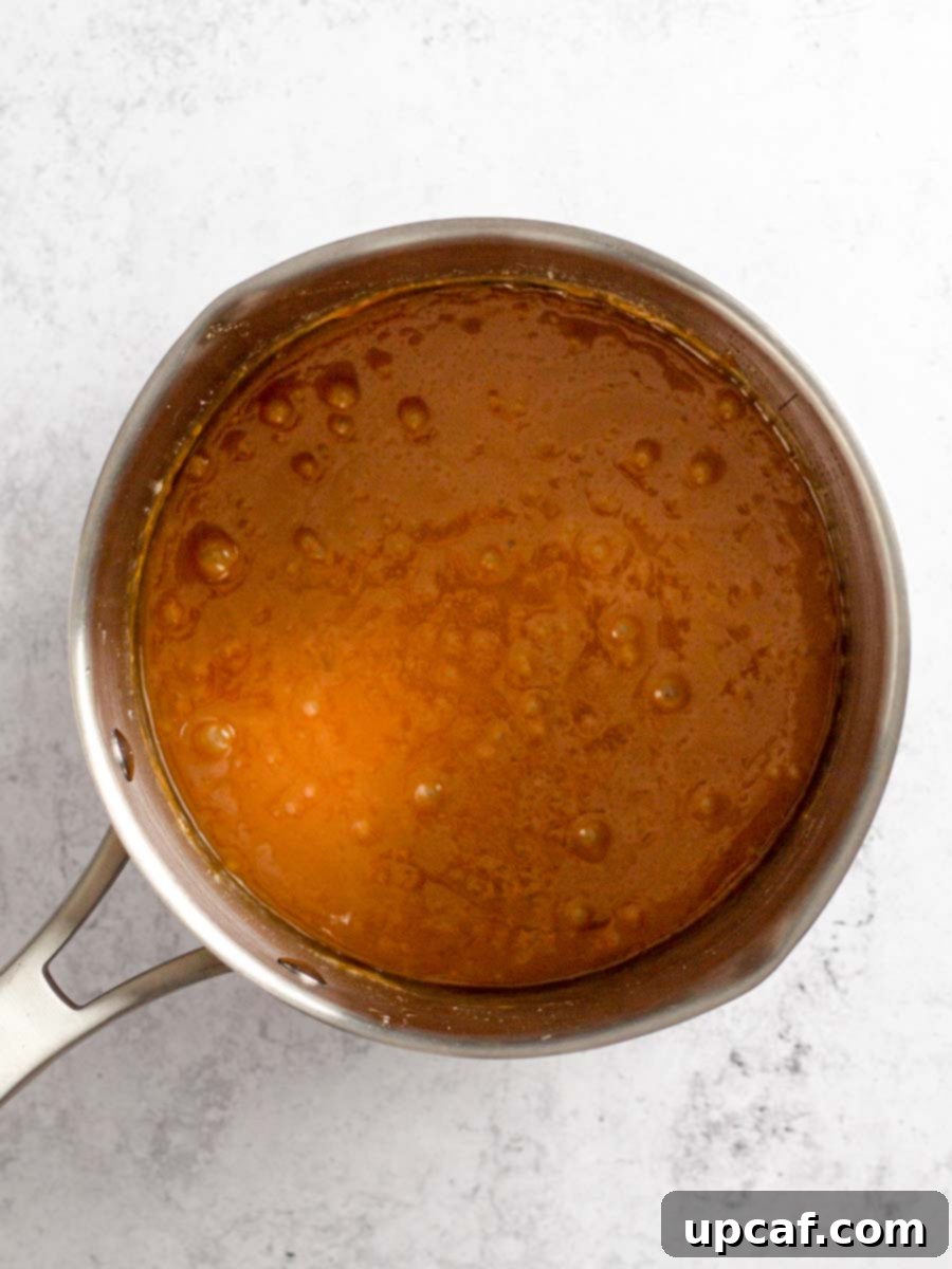 The finished caramel sauce resting in the saucepan, looking rich, glossy, and ready to be transferred.