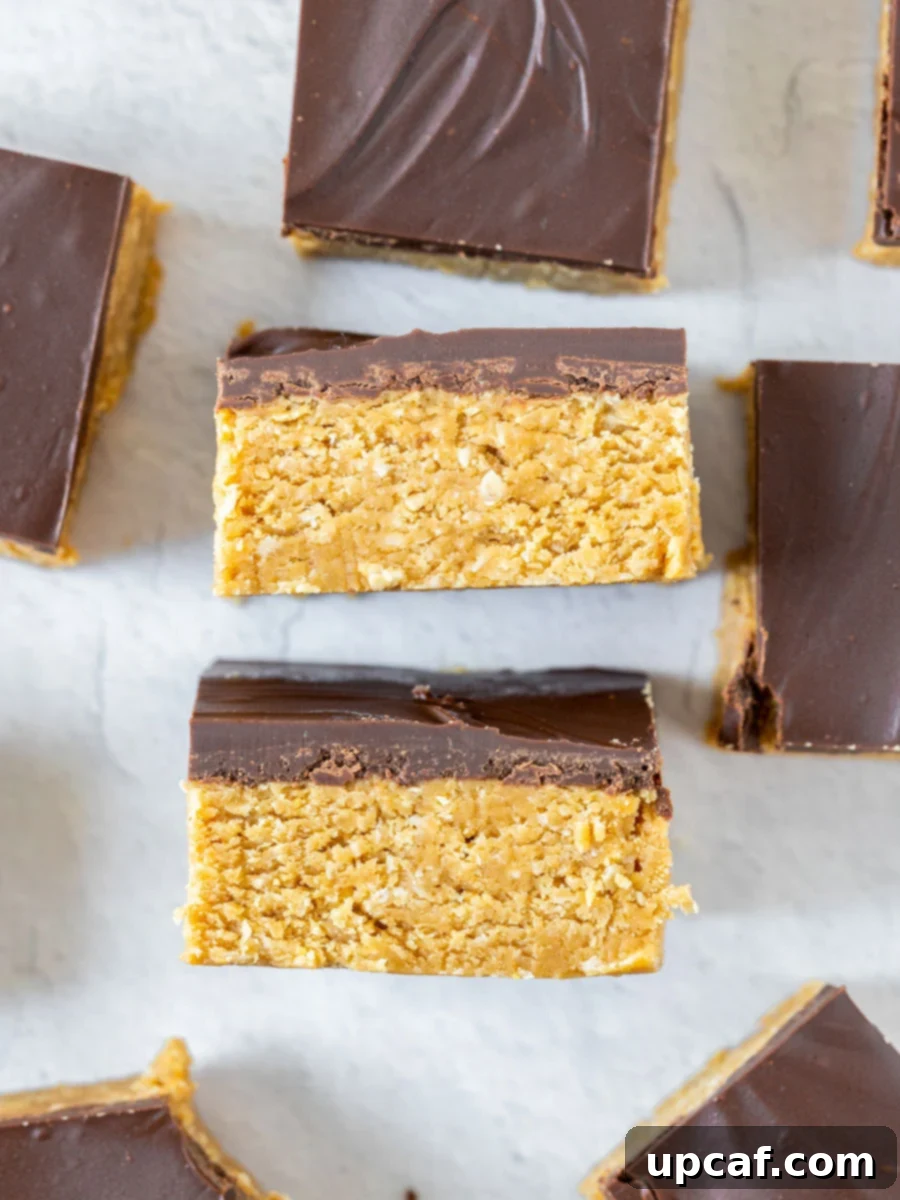 Delicious bars of the chocolate peanut butter oatmeal bars laid out on parchment paper