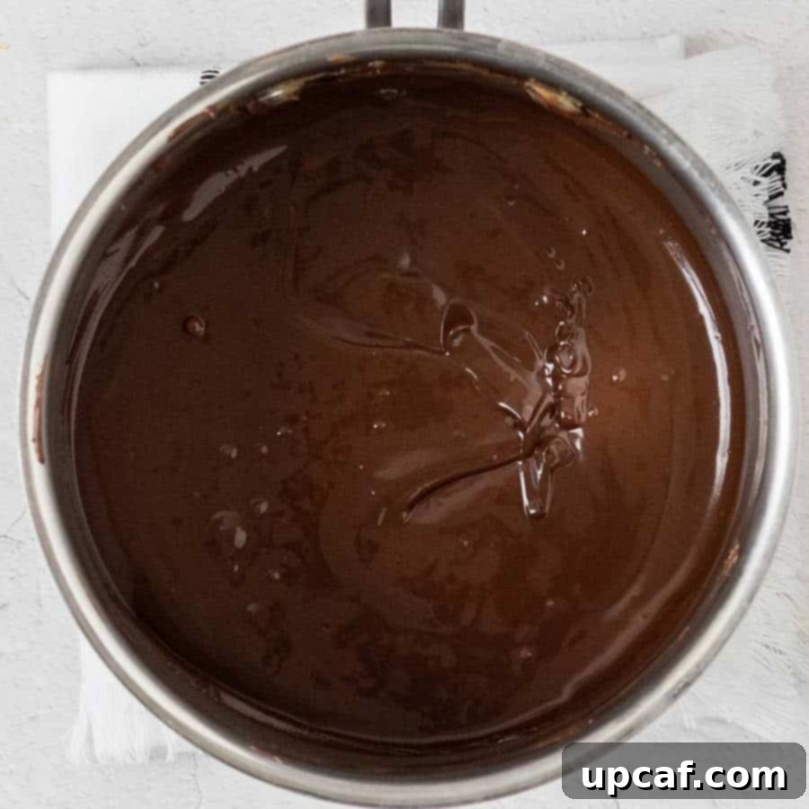 Melted chocolate, butter, and peanut butter mixture in a small pot on the stove.