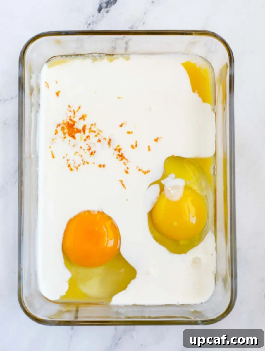 Ultimate Orange French Toast 4 Ingredients for custard added to a container to be mixed.