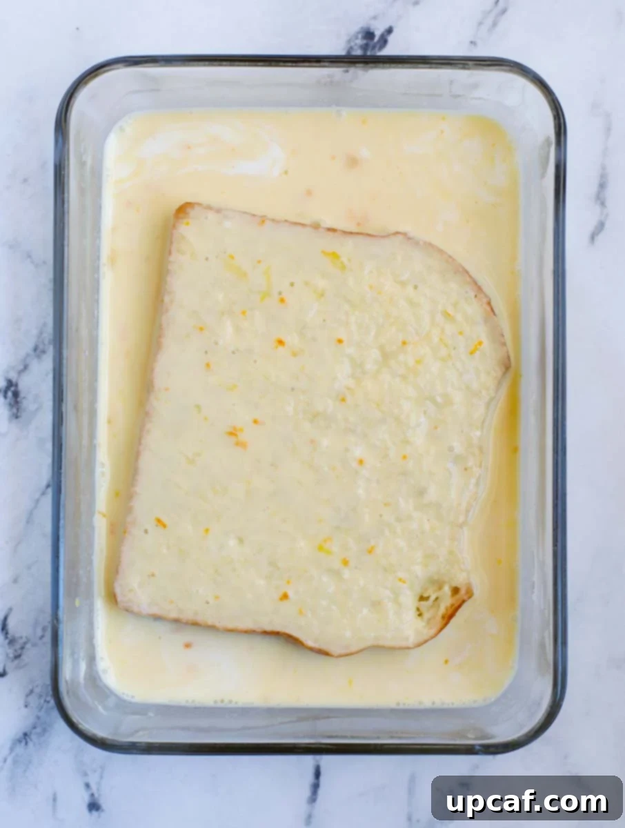 Ultimate Orange French Toast 6 Flipping the bread in the custard mixture to soak both sides.