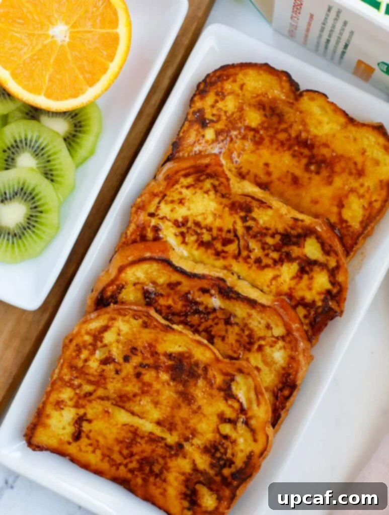 Ultimate Orange French Toast 7 A platter of four orange french toast pieces, stacked and ready to serve.