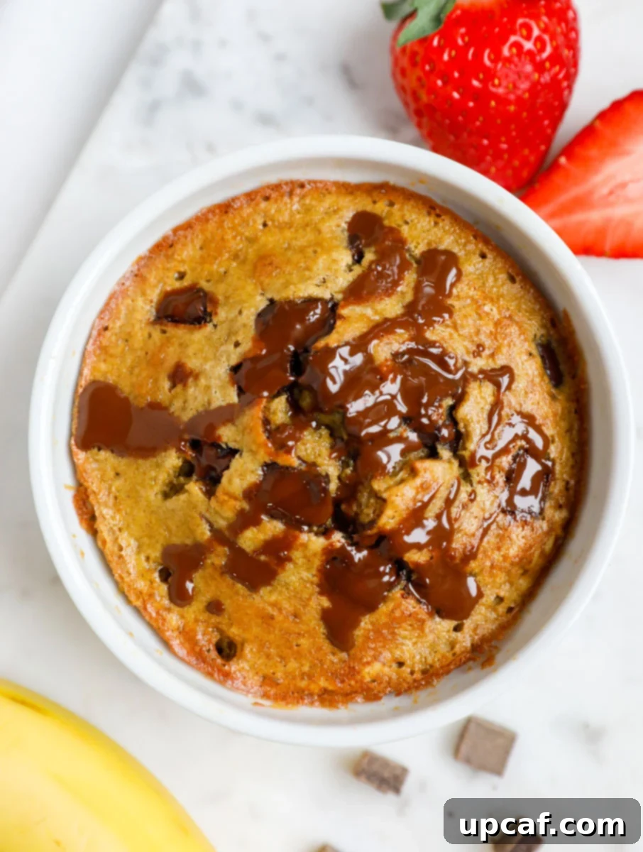 A perfectly baked individual serving of chocolate chip banana baked oats, ready to be enjoyed.
