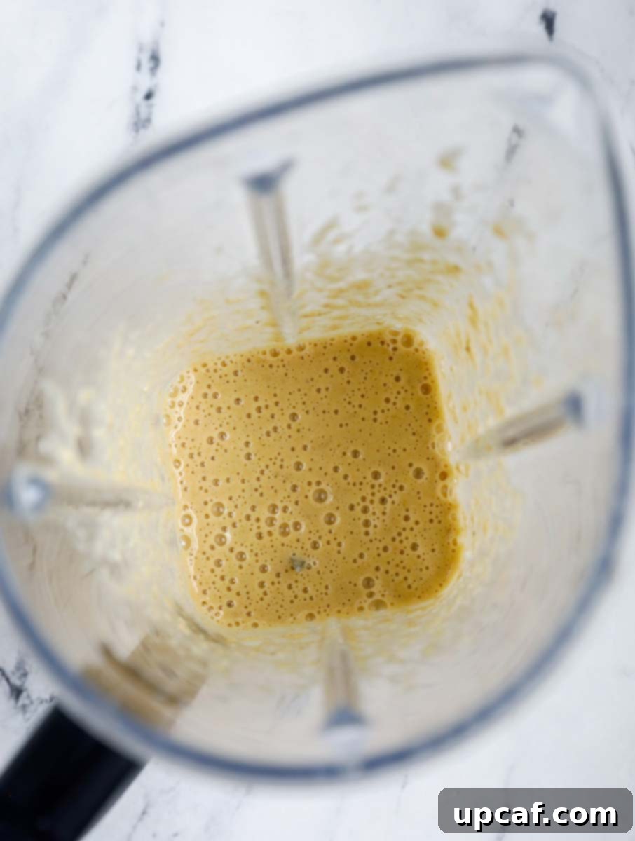 Smooth chocolate chip banana baked oats batter in a blender.