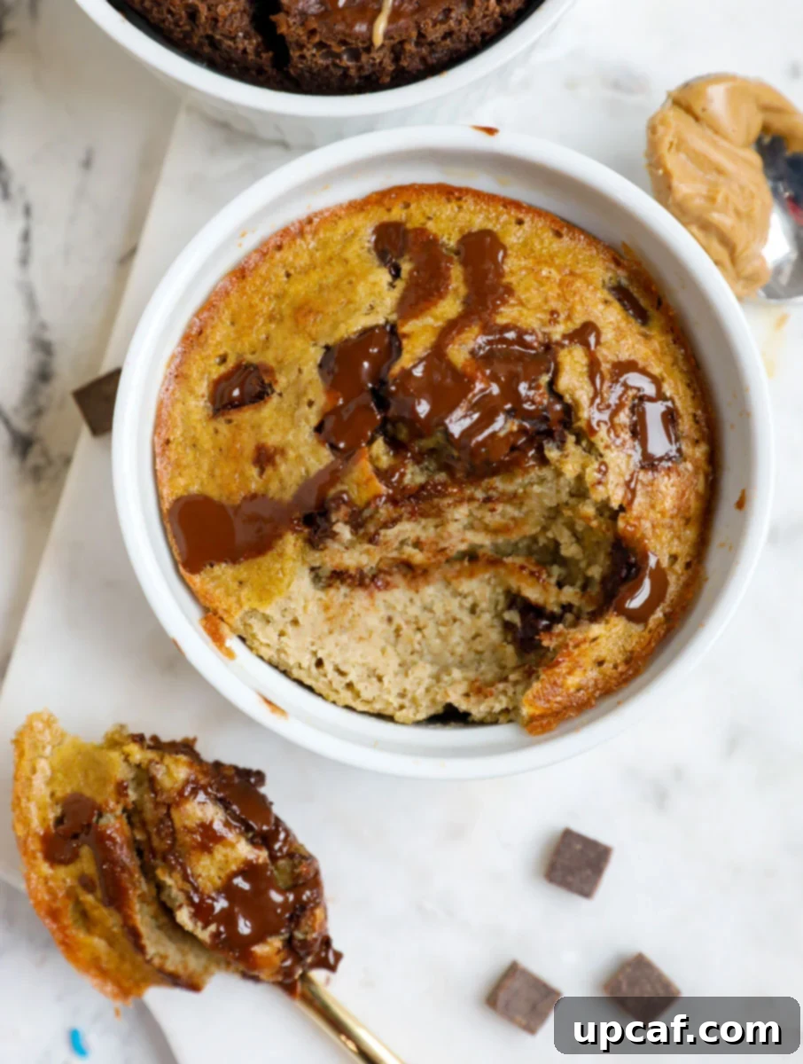 A spoonful of moist oatmeal cake being scooped out from a ramekin, revealing a soft interior.