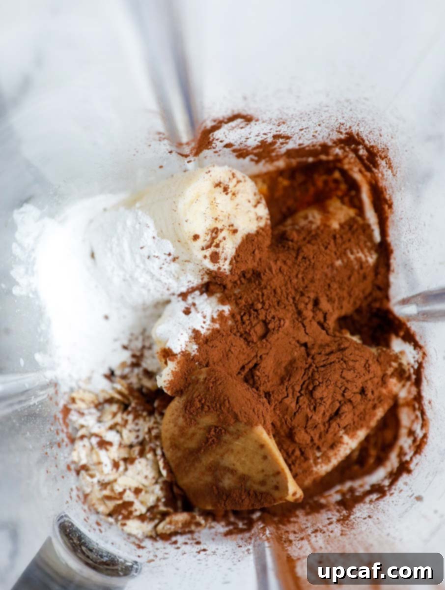 Chocolate Peanut Butter Banana Oatmeal Bake 4 Ingredients for peanut butter chocolate baked oats inside of a blender.