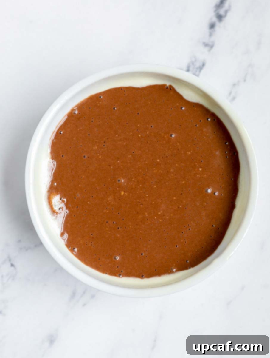 Chocolate Peanut Butter Banana Oatmeal Bake 6 Chocolate peanut butter baked oats batter in a ramekin.