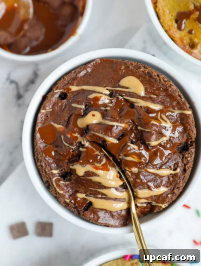 Chocolate Peanut Butter Banana Oatmeal Bake 9 A spoon inserted into a ramekin of baked oats.