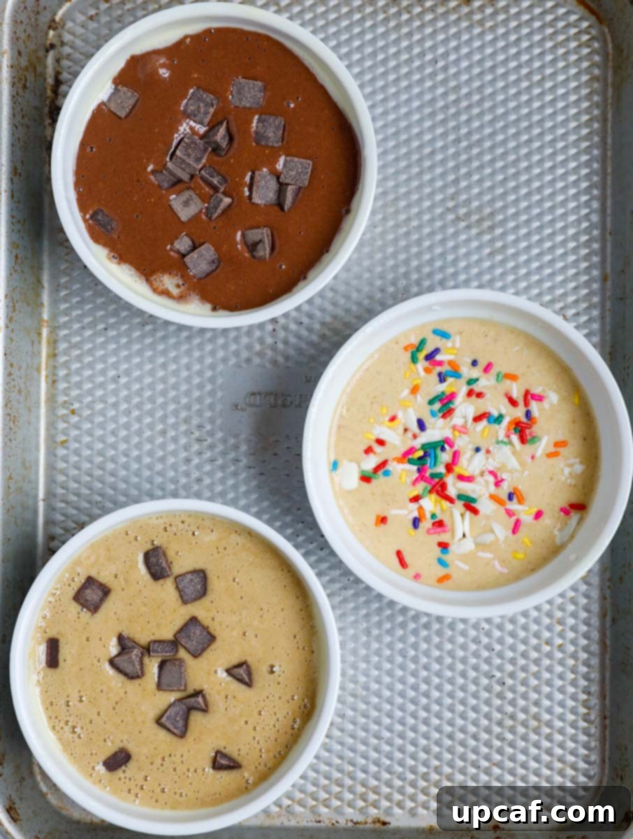 Baked Oats Reimagined Three Delicious Versions 6 Set of three ramekins with various batters for baked oats inside, ready for the oven.