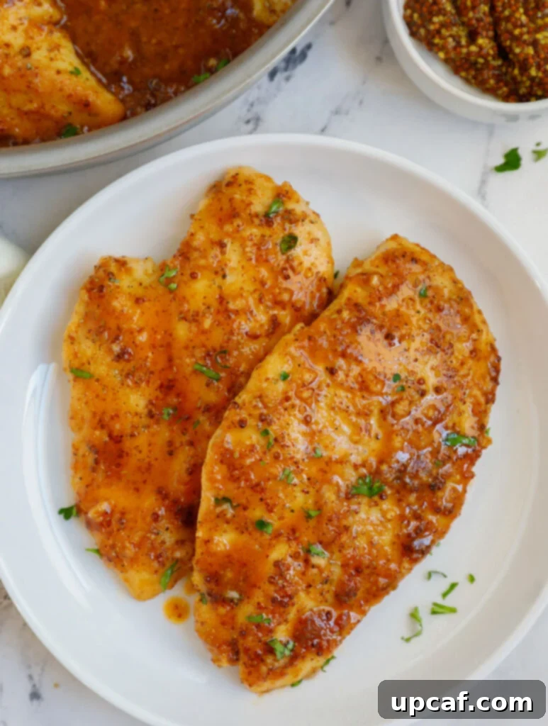 A plate of chicken with honey mustard sauce.