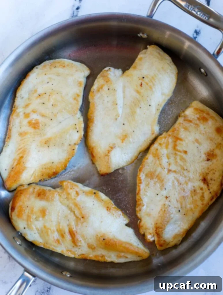 Pan searing chicken breasts.
