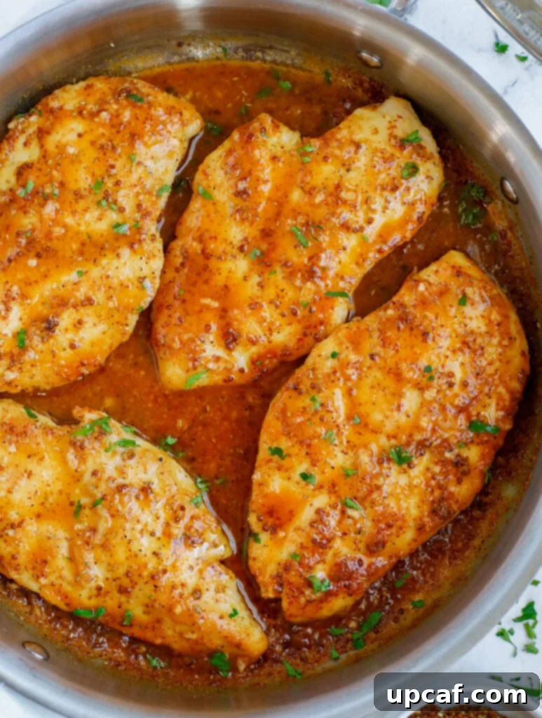 Honey mustard chicken in a pan.