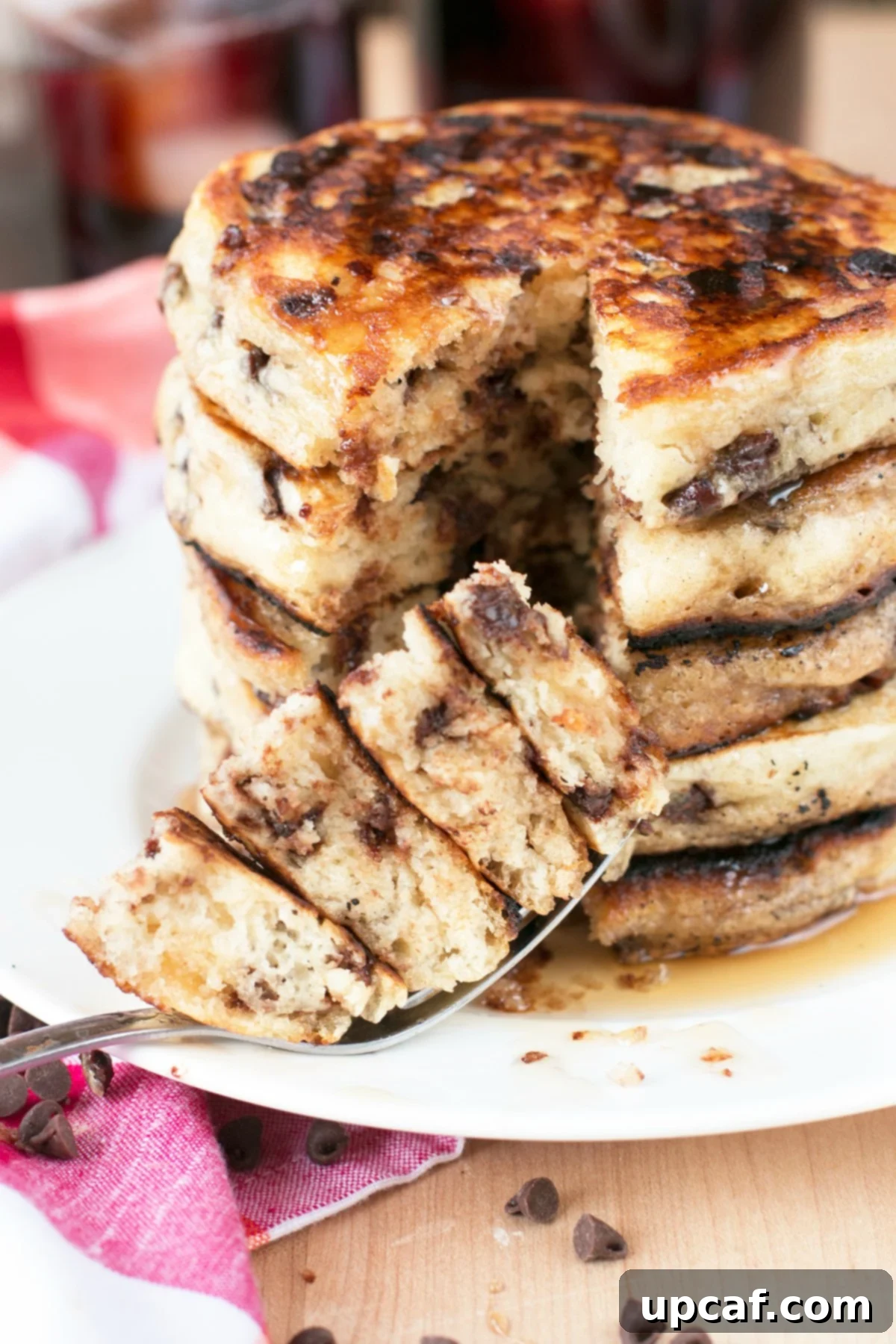 Stack of chocolate chip pancakes with a bite taken from them
