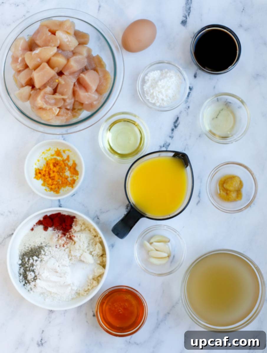 Wholesome Orange Chicken 3 Overhead view of all the fresh ingredients needed to prepare healthy orange chicken, laid out on a clean surface.