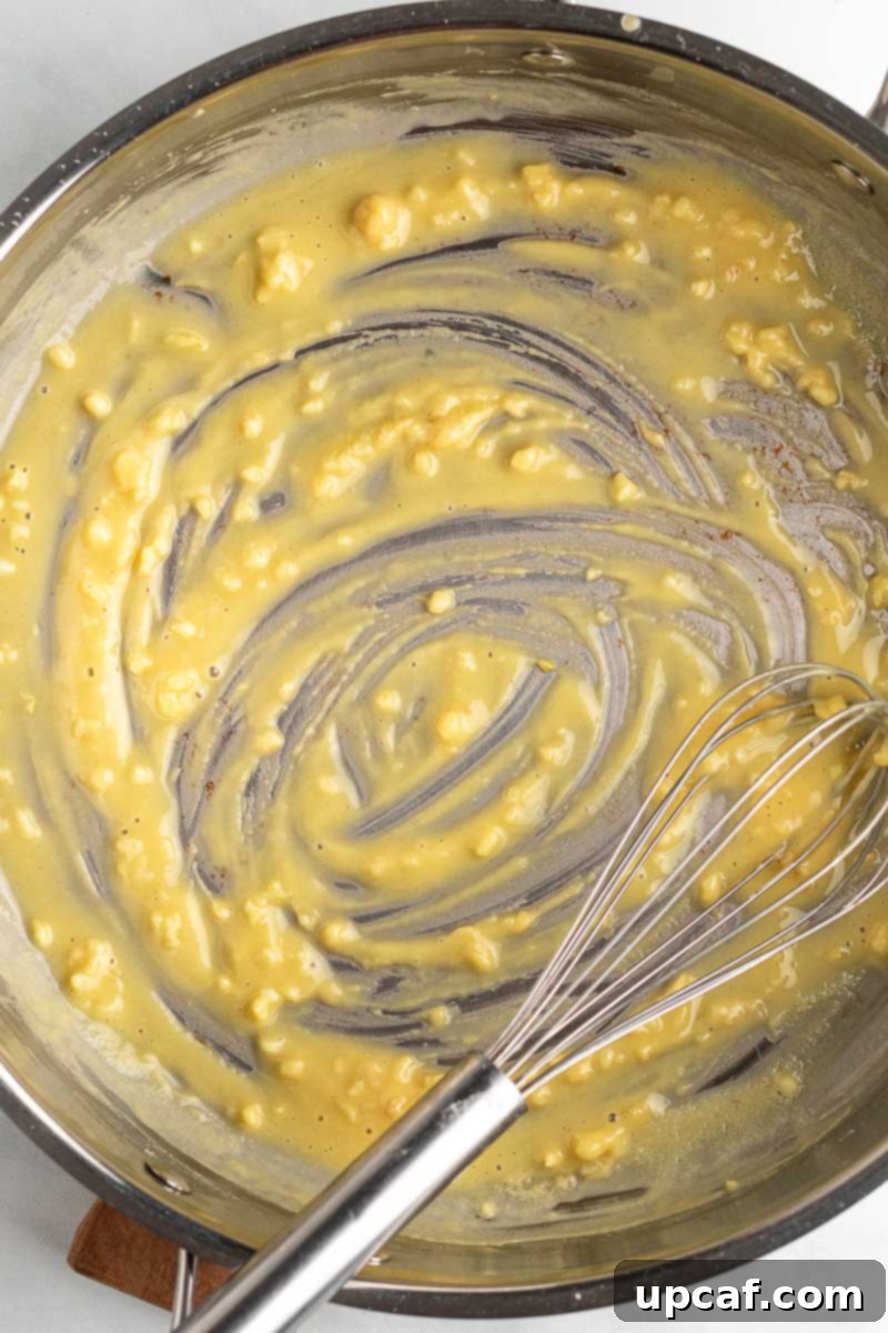 Close-up of butter and flour being cooked together in a skillet to form a roux.