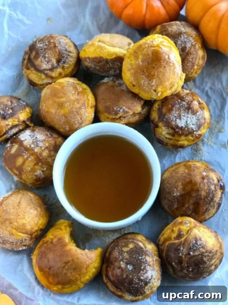 Pumpkin Pancake Bites with a bowl of syrup, ready to be enjoyed