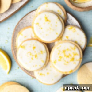 Tangy Lemon Glazed Shortbread 13 top down shot showing the lemon cookies with icing on a plate with blue background