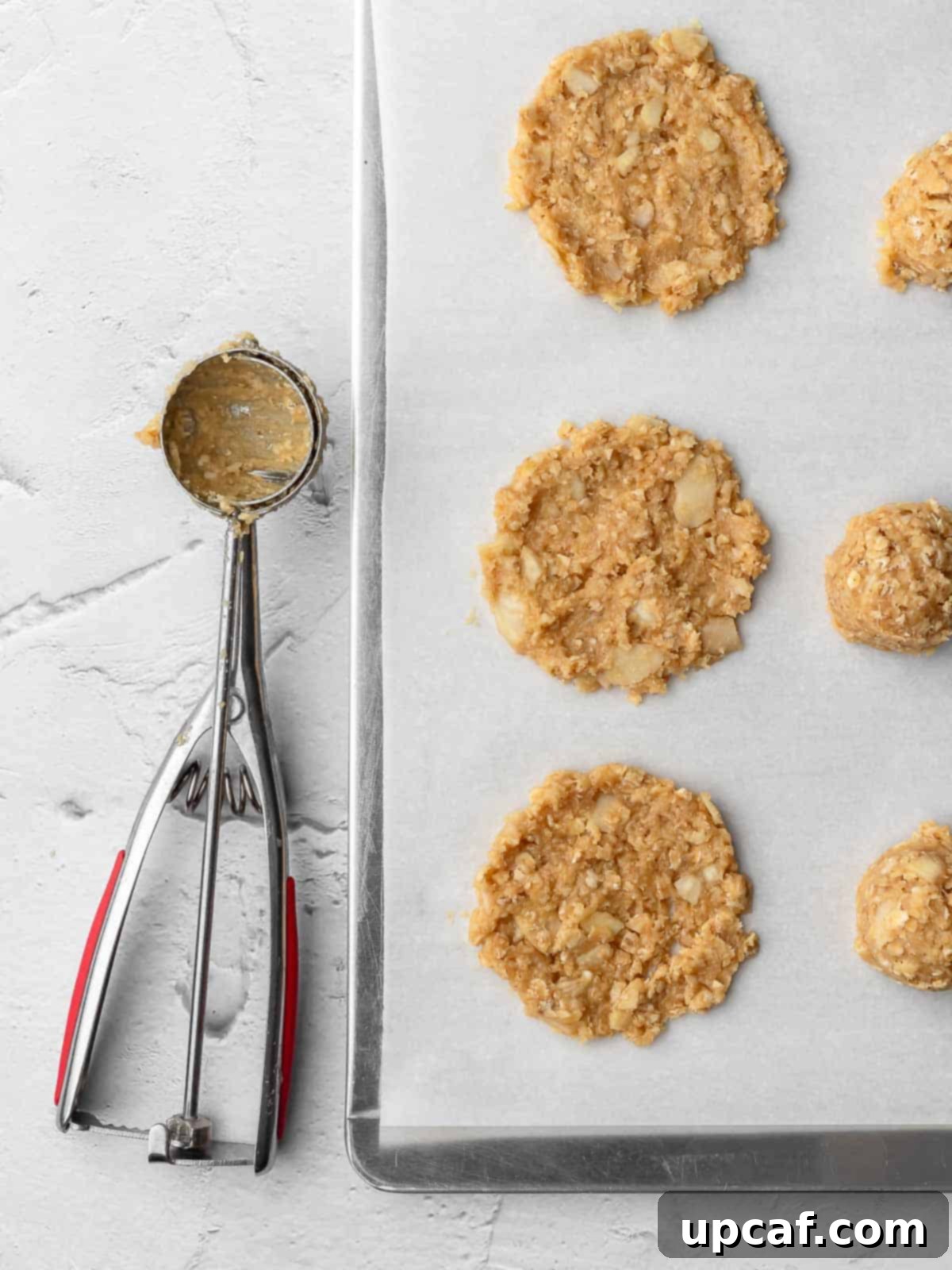 crispy almond cookie on a sheet pan before baking