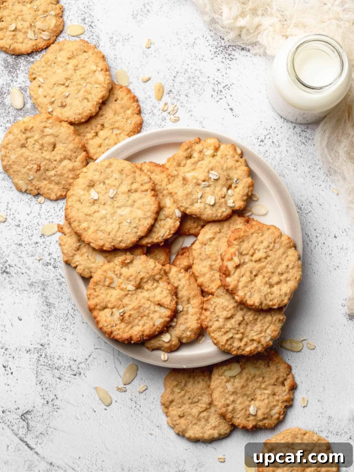 Crispy Almond Cookie on a plate with a bottle of milk next to it.