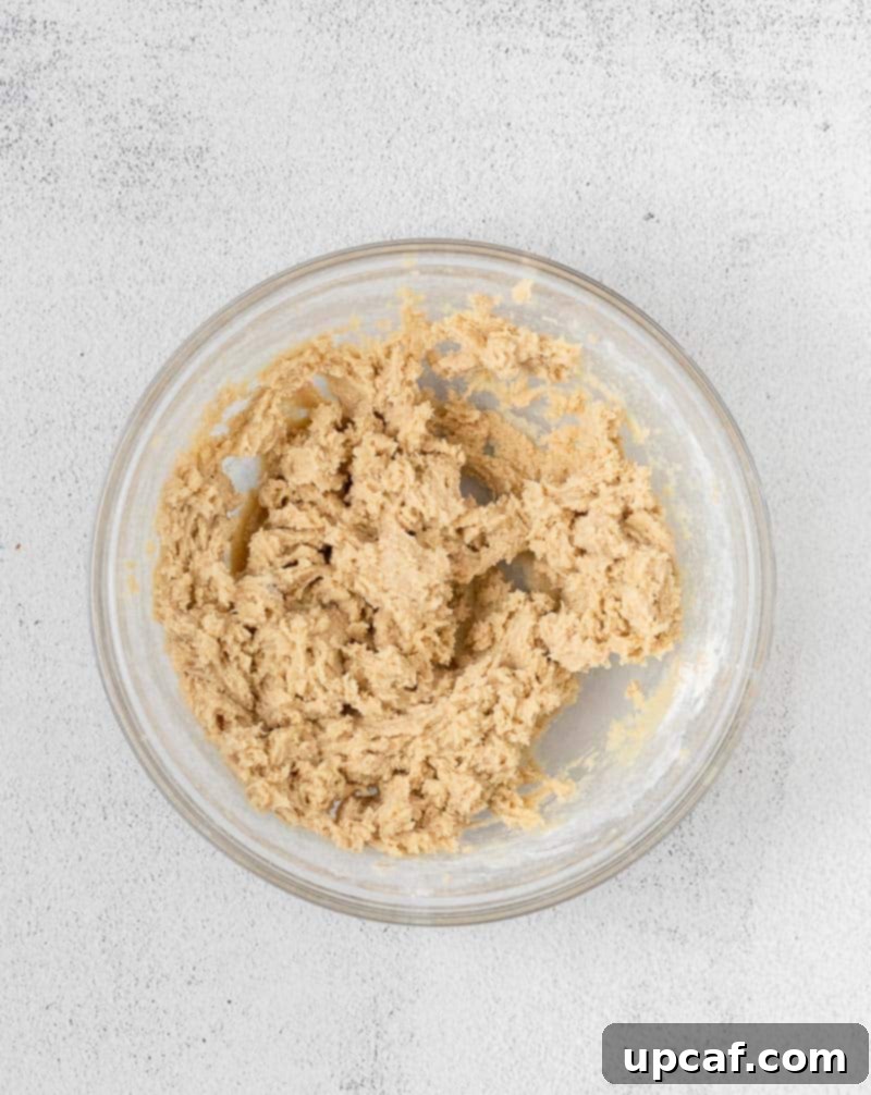 Irresistible Eggless Cookie Dough 5 Creamed butter and sugar mixture in a mixing bowl, showing the fluffy texture achieved before adding other ingredients.