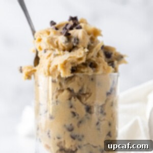 Irresistible Eggless Cookie Dough 8 edible cookie dough in a clear glass with a spoon inside
