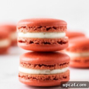 two pieces of red velvet macaron stacked on top of each other