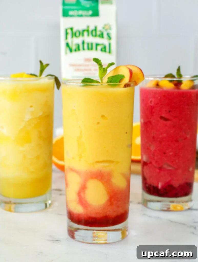 Three glasses of orange juice slushies.