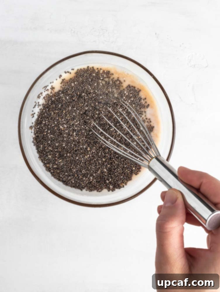 chia and milk being mixed in a bowl, showing the initial preparation