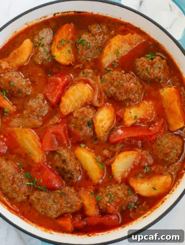 Hearty Kafta and Potato Stew 13 A rustic Dutch oven filled with bubbling Kafta and Potato Stew, ready to be served, capturing the warmth and comfort of home cooking.