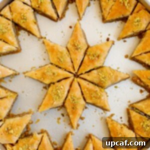 Walnut baklava in a pan with pieces removed.