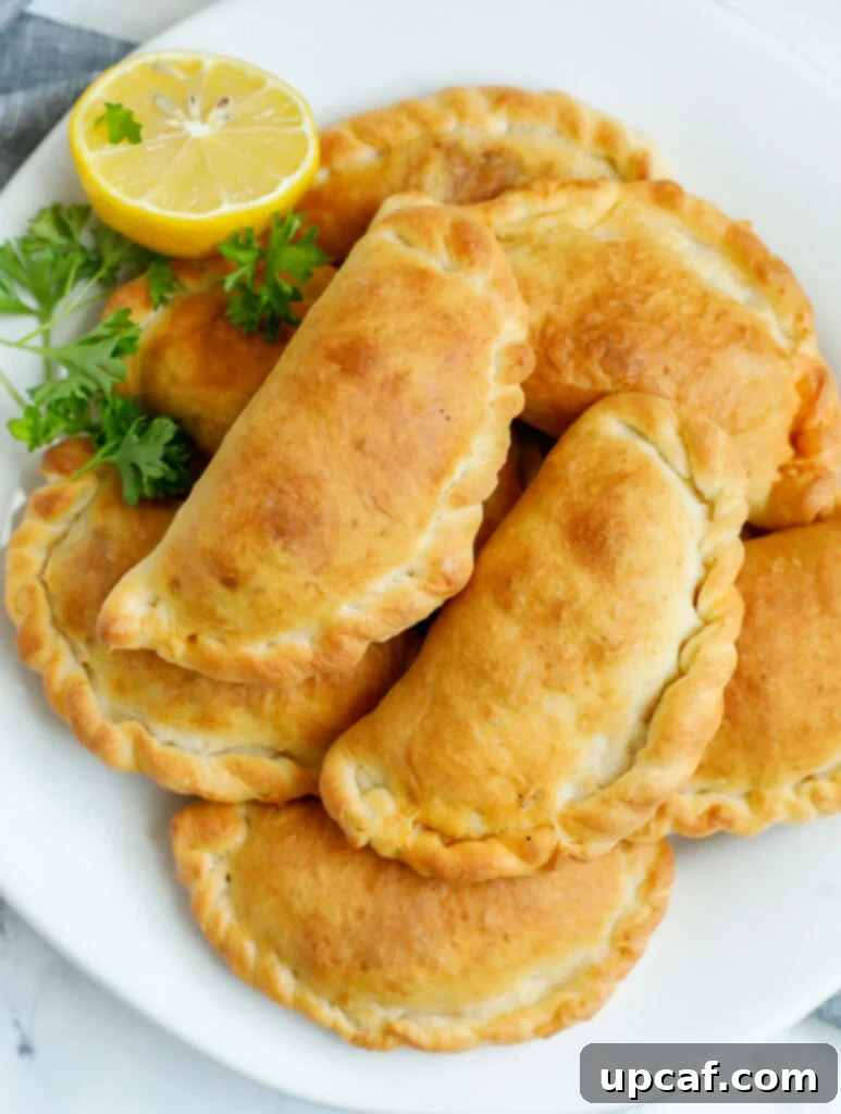 A platter of freshly baked individual Lebanese meat pies, golden and inviting.