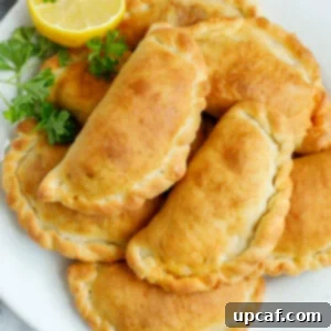 A platter of freshly baked individual meat pies.