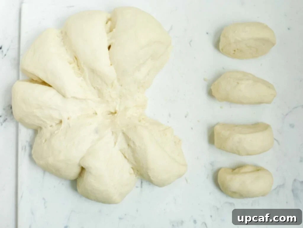Demonstrating the cutting of dough into smaller portions for individual pies.