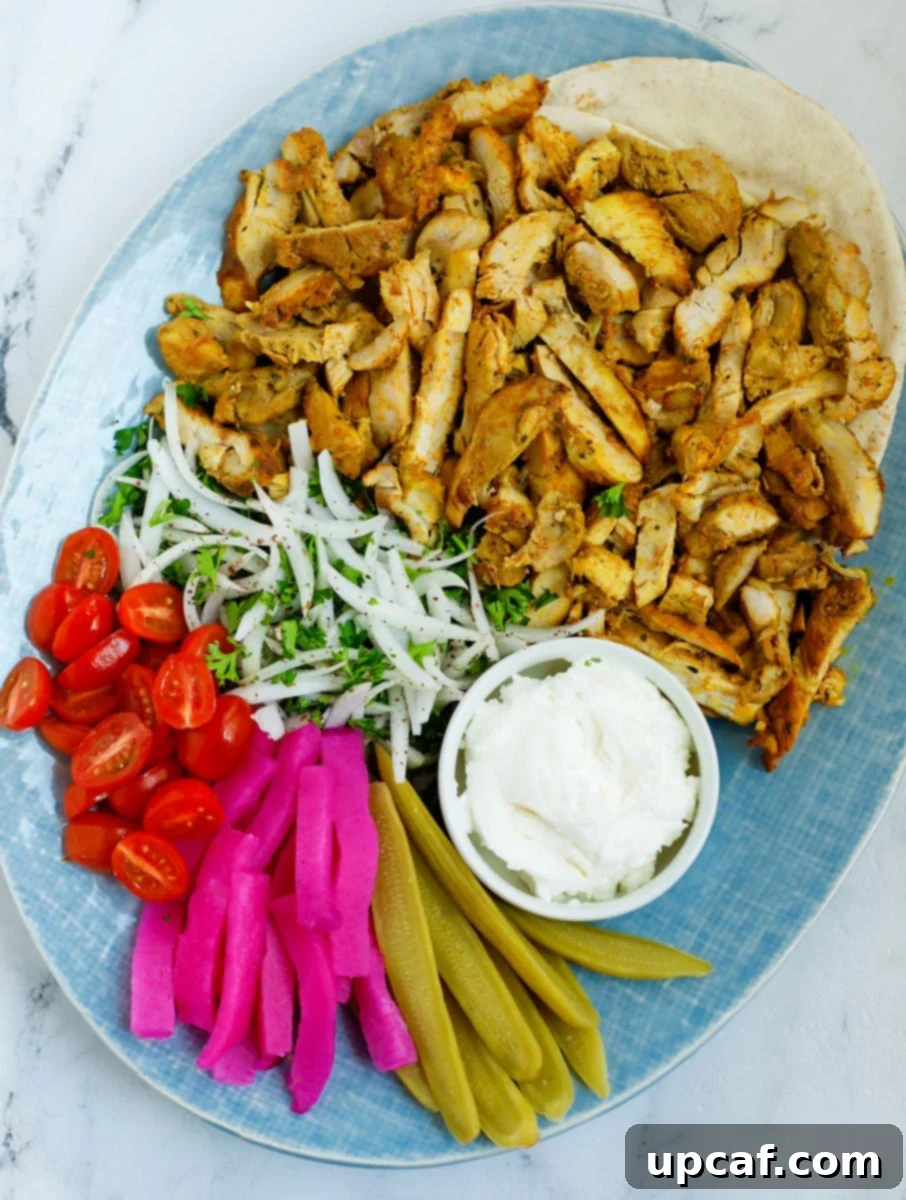 A platter of Lebanese chicken shawarma beautifully arranged for serving.