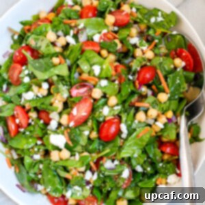 A plate of chickpea and spinach salad.