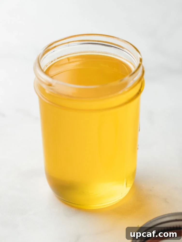 A mason jar filled with golden, homemade ghee, symbolizing purity and culinary richness.