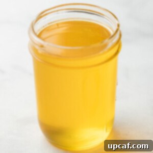 Ghee in a mason jar, golden and ready to use.