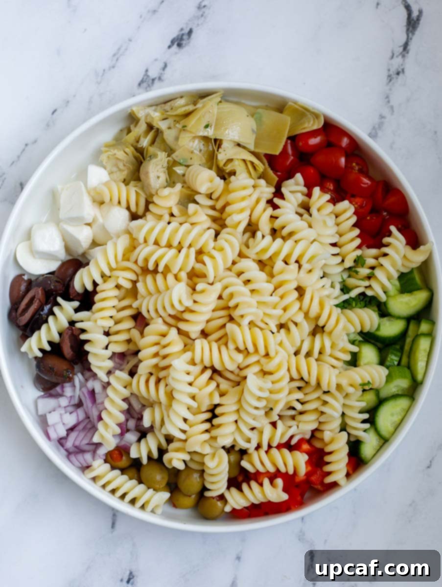 Vibrant Mediterranean Pasta Salad 6 Cooked and drained rotini pasta in a large mixing bowl, ready for the additions.