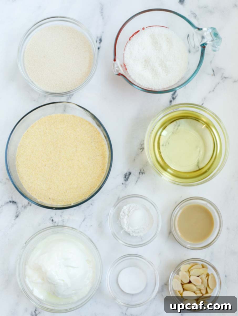 A collection of Basbousa ingredients neatly laid out on a kitchen counter, including semolina, sugar, coconut, and yogurt.