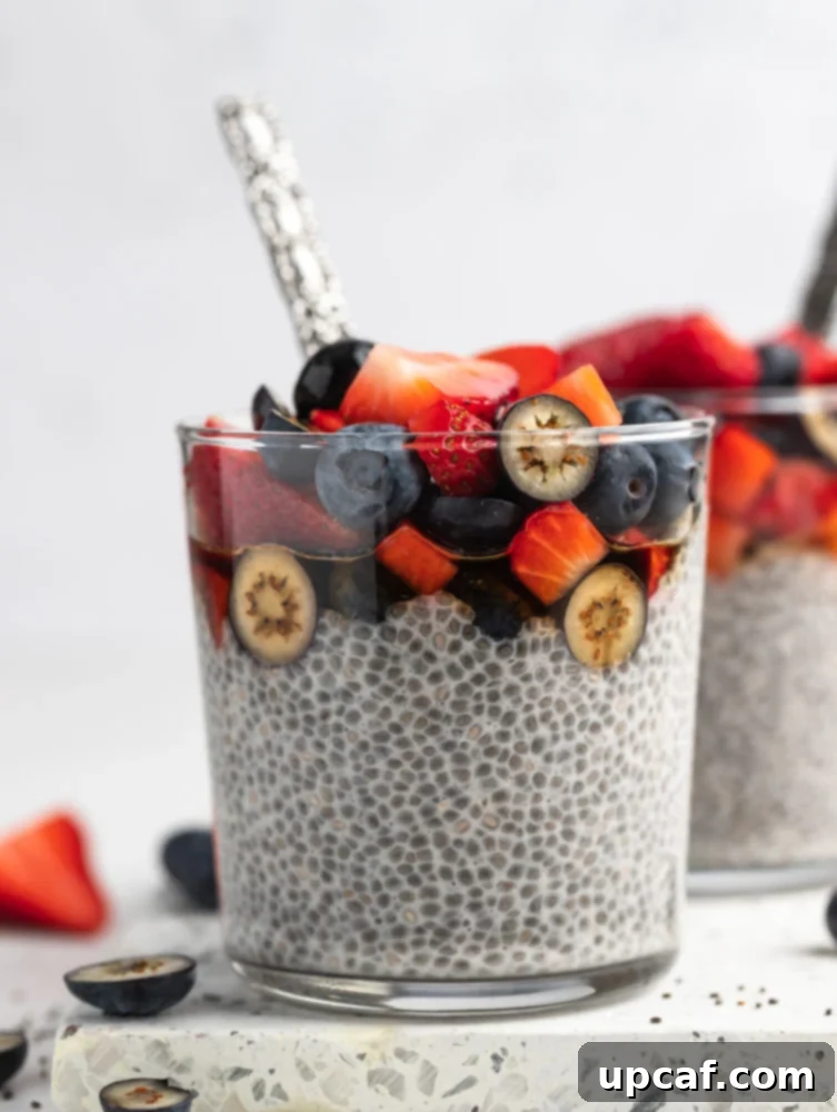 Close-up shot of creamy overnight chia pudding topped with fresh berries, sliced banana, and a drizzle of maple syrup, ready to be enjoyed as a healthy breakfast.