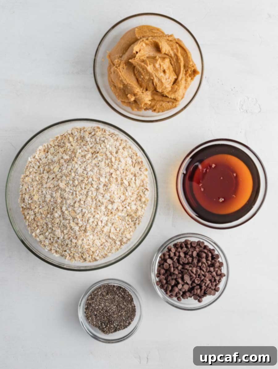 Organized display of all ingredients required to make No-Bake Energy Balls on a wooden surface.