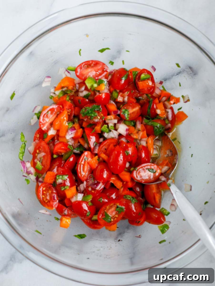 Creamy Avocado Chicken Salad 4 A bowl of vegetables mixed with the olive oil and lemon juice.