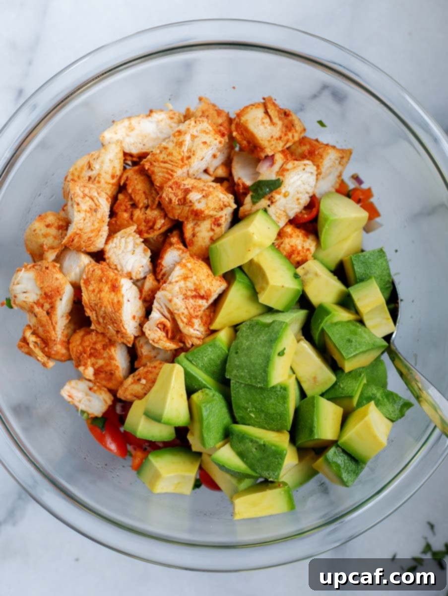 Creamy Avocado Chicken Salad 6 A bowl with the ingredients needed to make an avocado chicken salad.