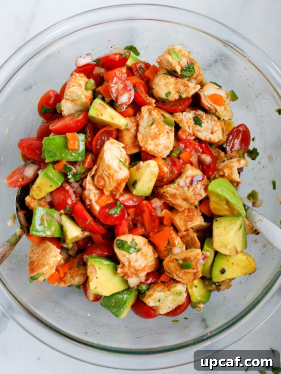 Creamy Avocado Chicken Salad 7 A bowl of the ingredients for avocado chicken salad being mixed together.