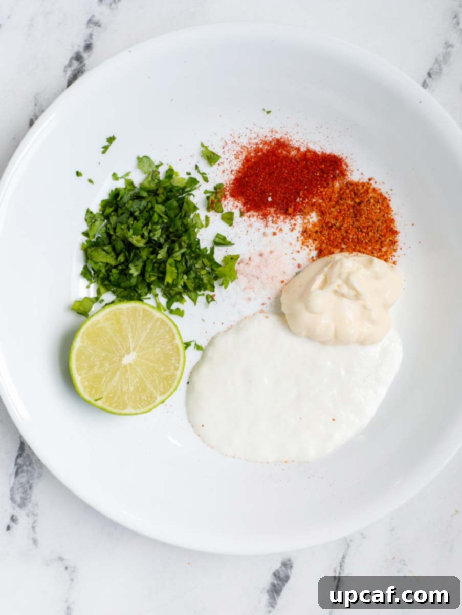 Authentic Mexican Elote 4 Ingredients for creamy Mexican street corn sauce being mixed in a bowl.