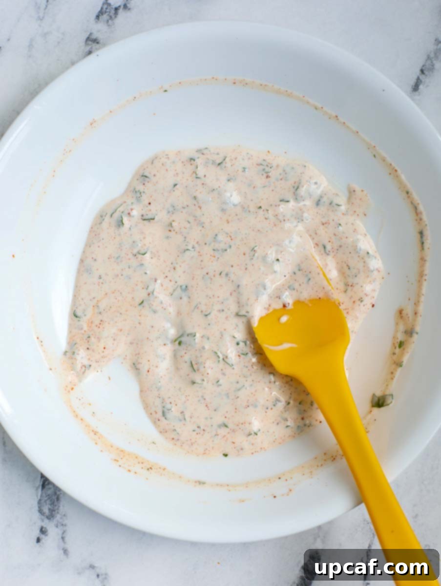 Authentic Mexican Elote 5 Smooth, mixed Mexican street corn sauce in a bowl, ready for application.