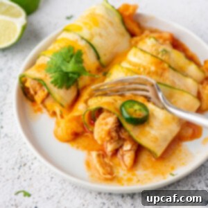 Southwest Chicken Zucchini Enchiladas 9 A fork cutting into a piece of chicken zucchini enchiladas